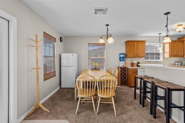 211 Ocean Dr, Surfside Beach, TX 77541 - dining room with dark carpet and a chandelier