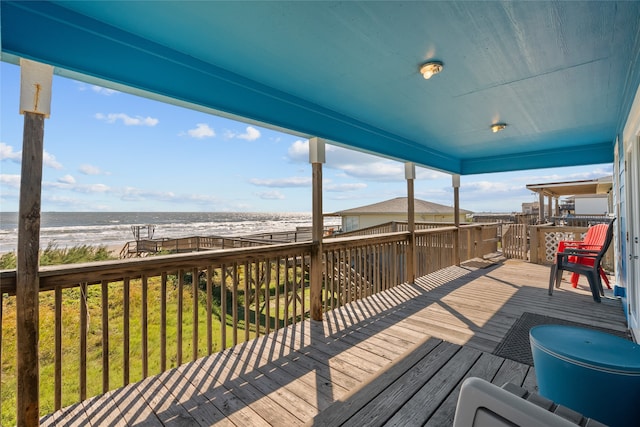 wooden terrace with a beach view and a water view