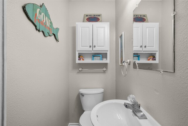 211 Ocean Dr, Surfside Beach, TX 77541 - bathroom featuring a sink and a textured wall