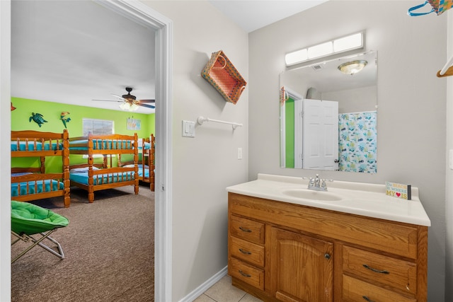 bathroom with ceiling fan, vanity, and tile patterned floors