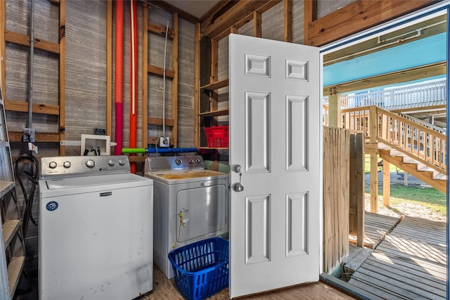 211 Ocean Dr, Surfside Beach, TX 77541 - laundry area with washing machine and clothes dryer, wood walls, and wood finished floors