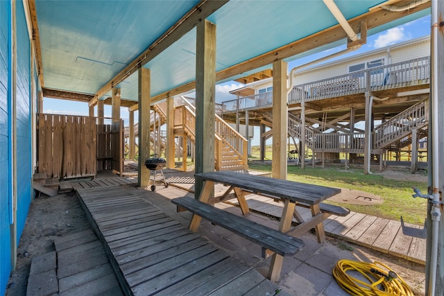 211 Ocean Dr, Surfside Beach, TX 77541 - deck featuring stairs and a lawn