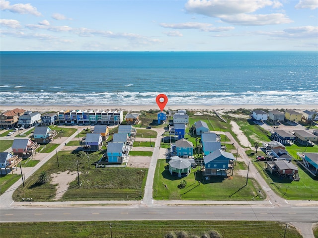 birds eye view of property featuring a view of the beach and a water view