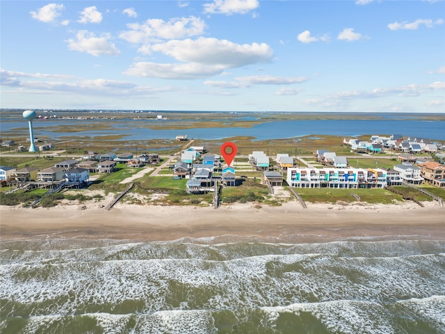 birds eye view of property featuring a water view and a beach view