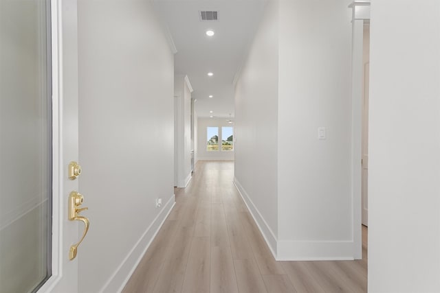 hallway with baseboards, recessed lighting, visible vents, and light wood-style floors