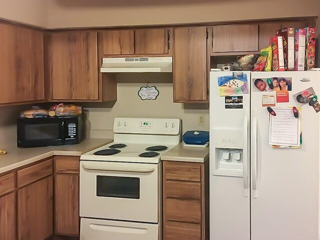 6217 Ludington Dr Unit 20-915, Houston, TX 77035 - kitchen with white appliances, under cabinet range hood, light countertops, and brown cabinets