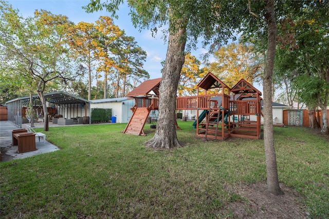 view of yard featuring a playground and a carport