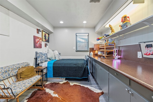 bedroom with dark hardwood / wood-style flooring