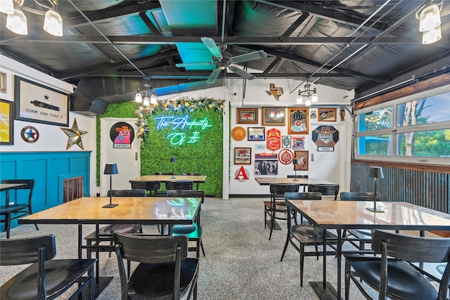 carpeted dining space featuring ceiling fan and lofted ceiling