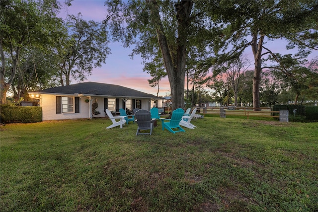 view of yard at dusk