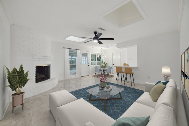 living room with a brick fireplace and ceiling fan