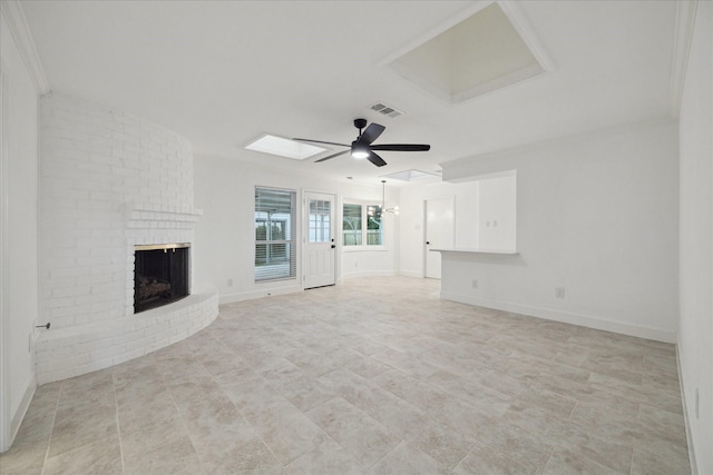 unfurnished living room with a brick fireplace, ceiling fan, and crown molding