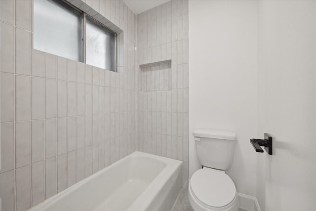 bathroom with toilet and tiled shower / bath combo