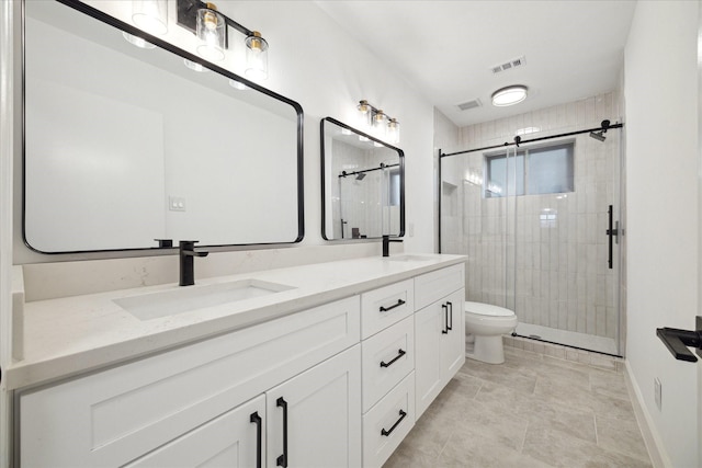 bathroom featuring a shower with door, vanity, and toilet