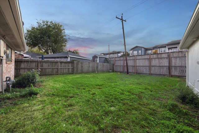 view of yard at dusk