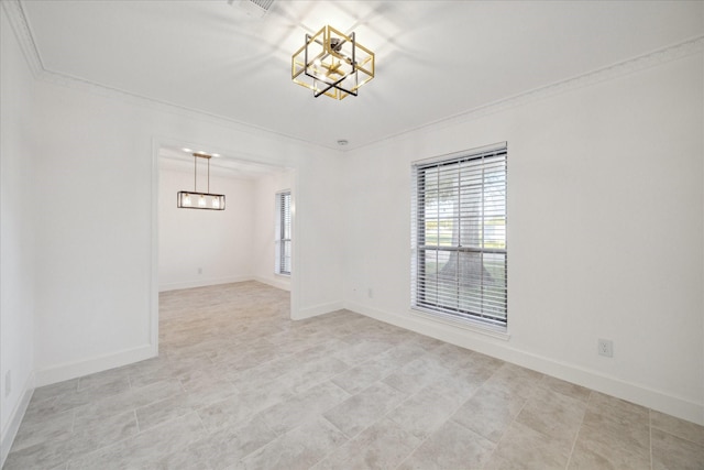 unfurnished room featuring ornamental molding and a notable chandelier