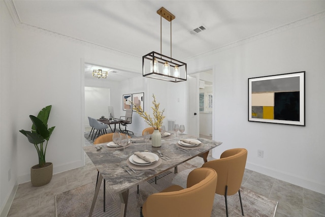 tiled dining area with ornamental molding and an inviting chandelier