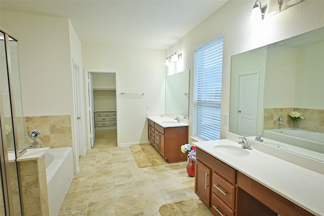 bathroom with vanity, tile patterned floors, and a bathtub