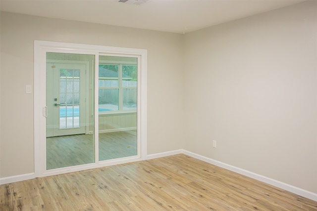 spare room featuring light hardwood / wood-style flooring