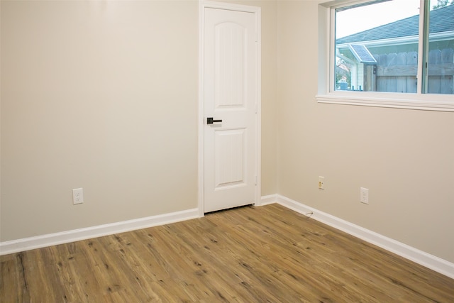 empty room with hardwood / wood-style floors