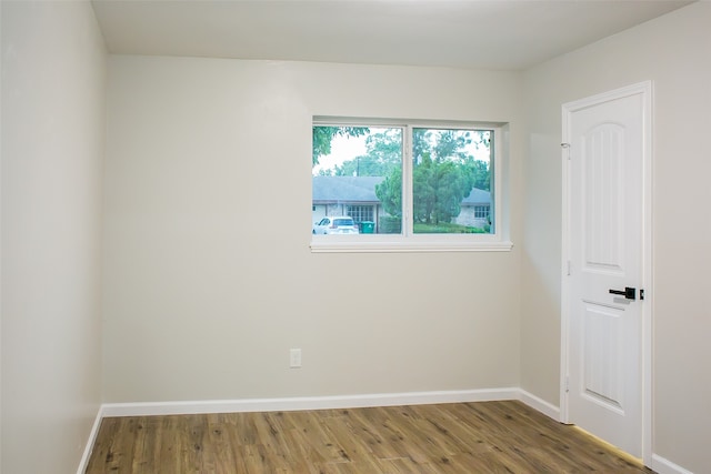 unfurnished room featuring hardwood / wood-style flooring