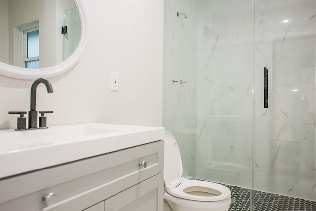 bathroom featuring a shower with door, vanity, and toilet