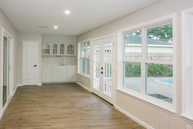 doorway featuring hardwood / wood-style flooring, sink, and french doors