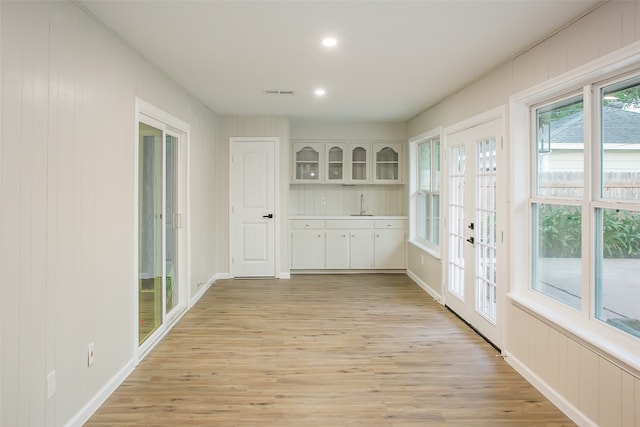 interior space featuring french doors, light hardwood / wood-style flooring, and sink