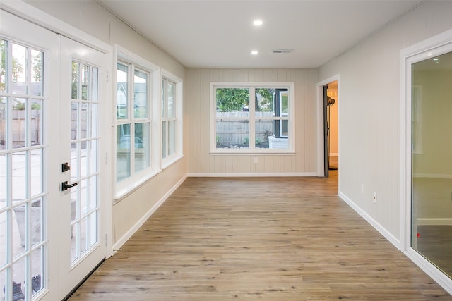 unfurnished sunroom featuring french doors and a wealth of natural light