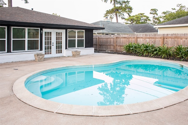 view of swimming pool featuring a patio and french doors