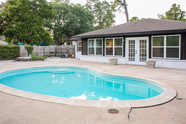 view of swimming pool with a patio area and french doors