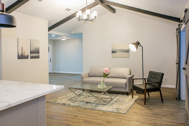 living room featuring a barn door, high vaulted ceiling, an inviting chandelier, beamed ceiling, and light hardwood / wood-style flooring