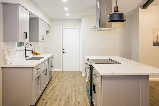 kitchen with stainless steel electric range, hanging light fixtures, sink, gray cabinetry, and island exhaust hood