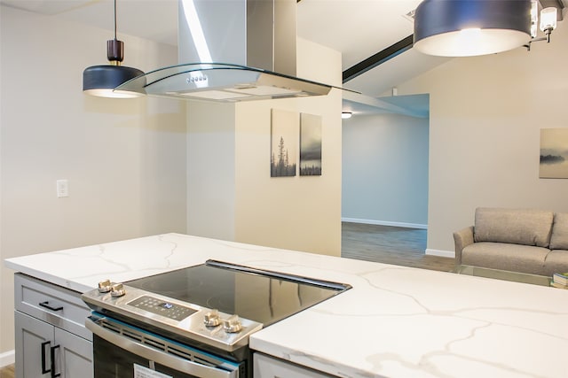 kitchen featuring island exhaust hood, hardwood / wood-style floors, light stone countertops, and electric range