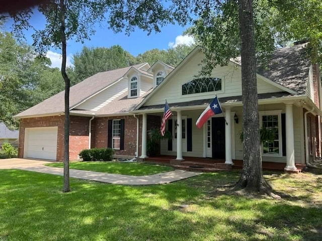 view of front facade featuring a garage, a porch, and a front lawn