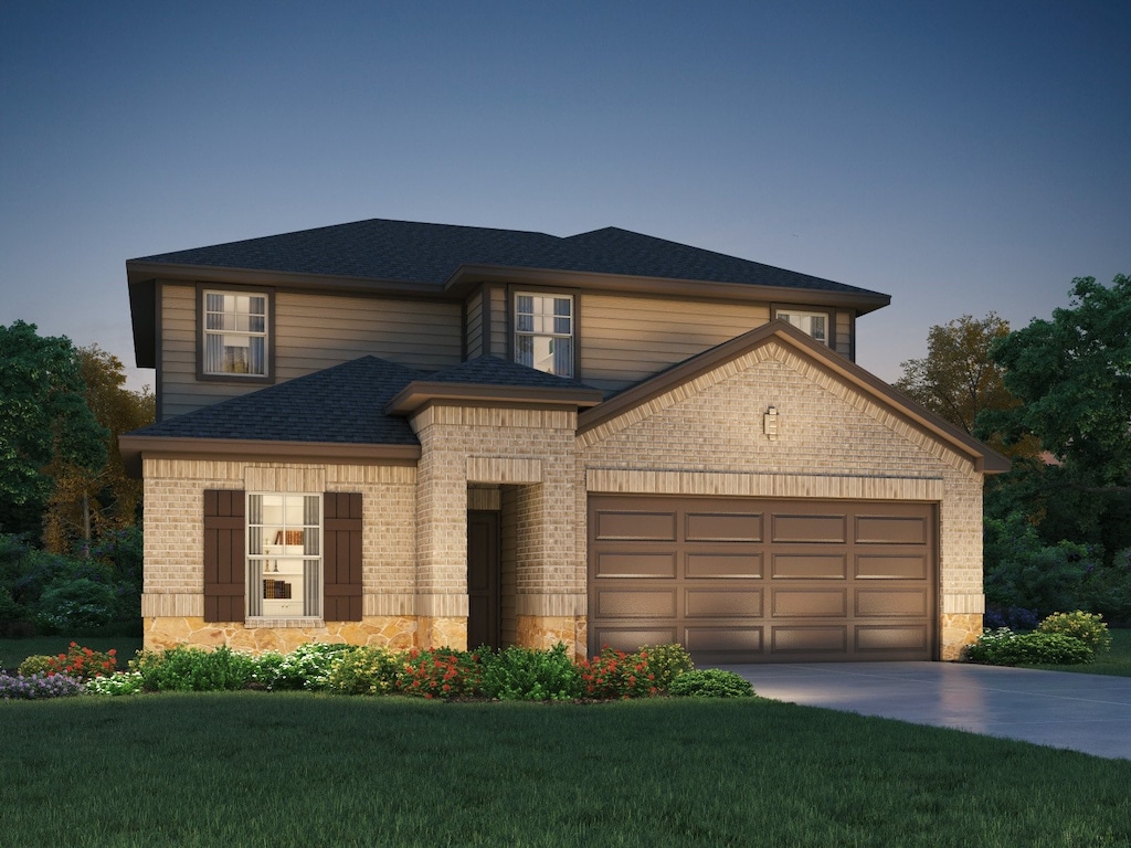 view of front of property with a front yard and a garage