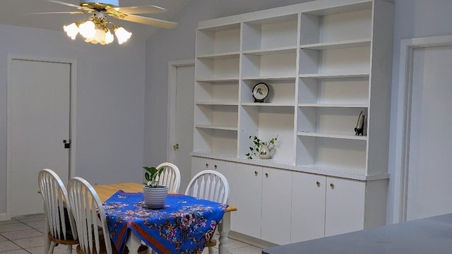 dining room with lofted ceiling, light tile patterned flooring, and ceiling fan