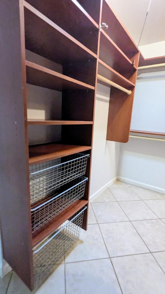 spacious closet featuring tile patterned flooring