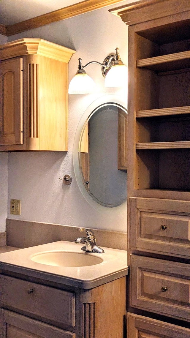 bathroom featuring vanity and crown molding