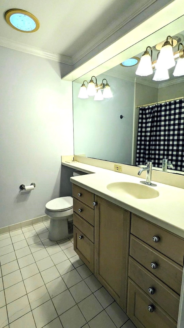 bathroom with toilet, vanity, tile patterned floors, and crown molding