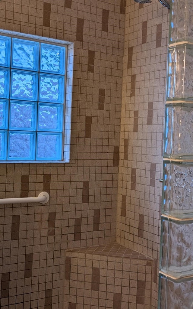 bathroom with tiled shower