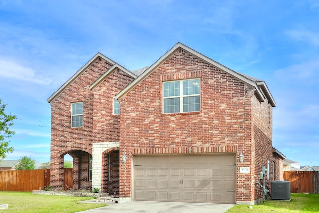 front of property featuring a garage and cooling unit