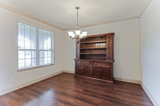 unfurnished dining area with dark wood-type flooring, an inviting chandelier, and ornamental molding