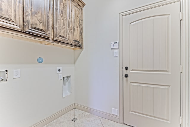 laundry area with cabinets, electric dryer hookup, hookup for a washing machine, and tile patterned floors