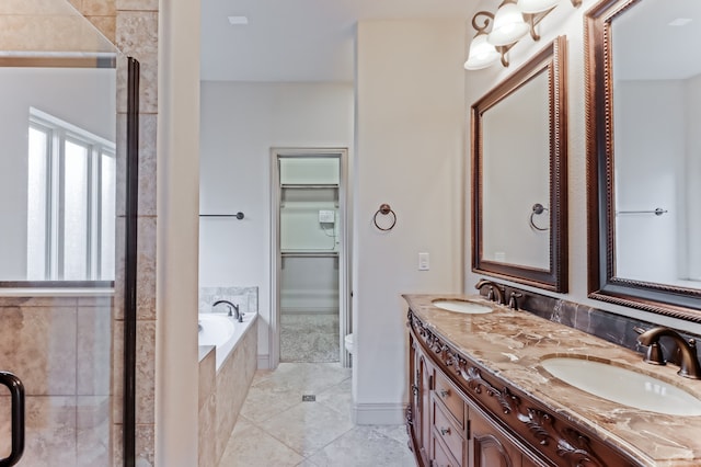 bathroom with vanity, tiled tub, and tile patterned floors