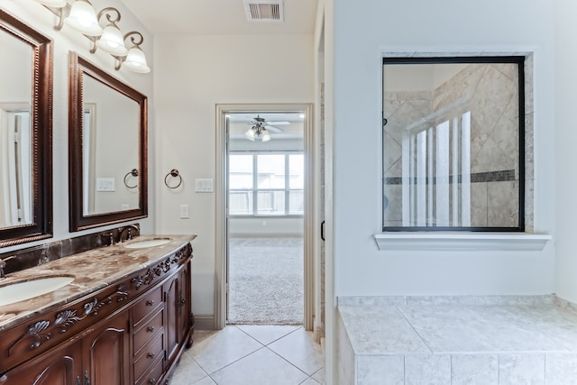 bathroom with a tile shower, vanity, tile patterned floors, and ceiling fan