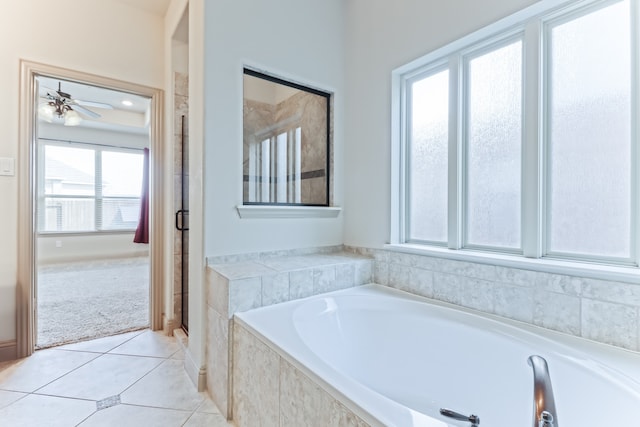 bathroom with a wealth of natural light, ceiling fan, tile patterned flooring, and separate shower and tub