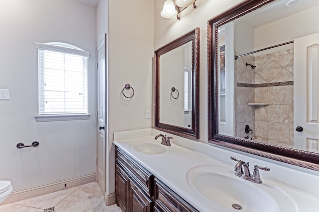 bathroom featuring tiled shower, tile patterned floors, toilet, and vanity