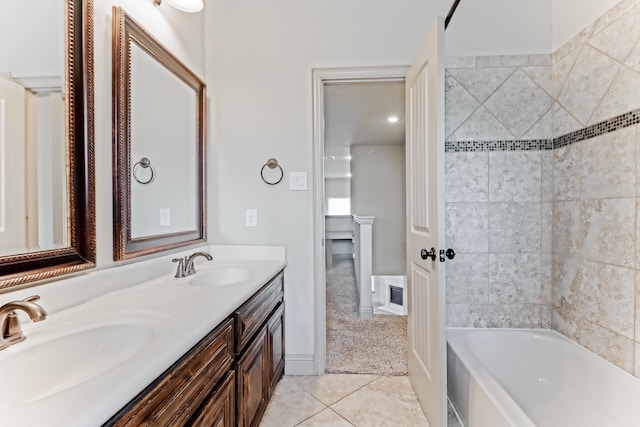 bathroom with a tub, tile patterned flooring, and vanity