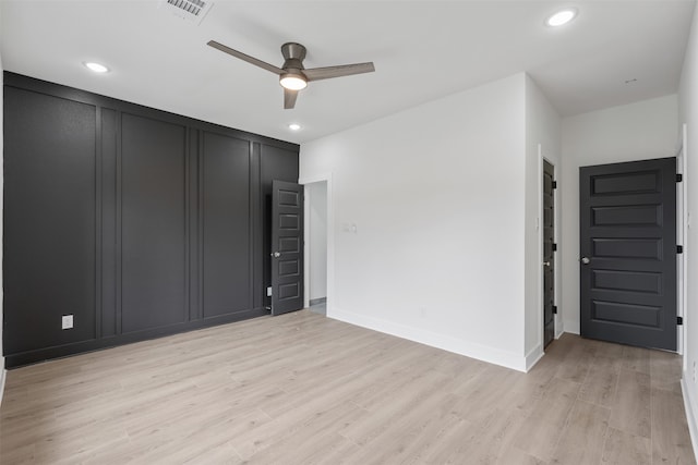 unfurnished bedroom with ceiling fan and light wood-type flooring